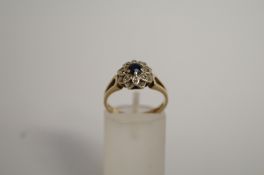 A sapphire and diamond 9ct gold cluster ring, finger size M