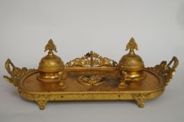 A 19th century ormolu inkstand, decorated with a coat of arms to centre with a phoenix rising from