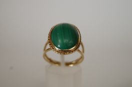 A malachite ring, the oval cabochon 16.5mm long; finger size R 1/2