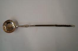 A Georgian silver coin set toddy ladle, makers mark worn, London 1786, on a horn twist handle,