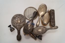 A collection of various silver backed hairbrushes