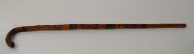 An early Mexican stick carved with bullfighting scenes etc.