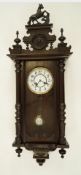 An early 20th century German 'Prancing Horse' Pendulum clock with a ceramic face