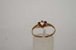 A garnet and cubic zirconia 9ct gold cluster ring, finger size Q