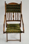 An early 20th century mahogany folding chair