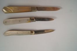 A silver and mother of pearl folding fruit knife and two other similar