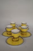 Five Shelly coffee cups with saucers and silver holders.