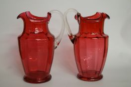 A pair of 20th century cranberry glass jugs