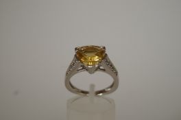A citrine 9ct white gold dress ring with stone set shoulders, finger size N