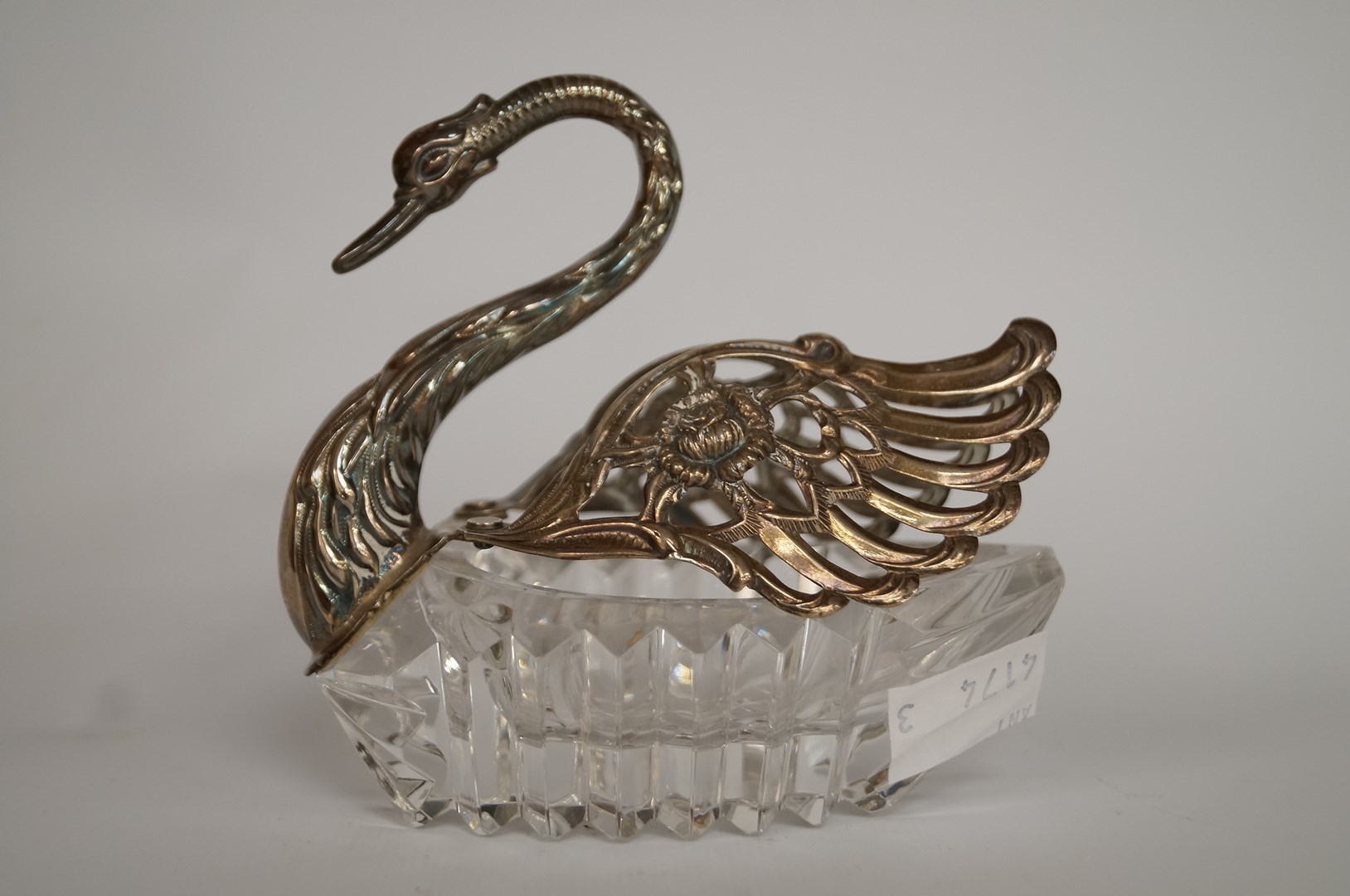 A silver and glass swan bon-bon dish, London import mark for 1975, glass body, hinged silver wings