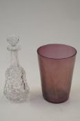 A glass decanter along with an amethyst vase
