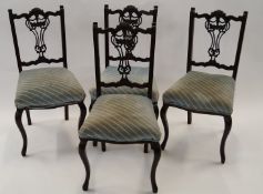 Four ornate dining chairs with covers