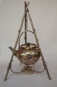 A spirit kettle, suspended from a rustic stand, with burner, by Martin Hall and Co; 37.5cm tall