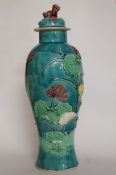 An oriental ground blue vase decorated with lilies