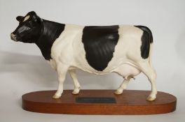 Beswick friesian cow on wooden plinth "A2607"