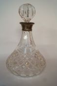 A glass decanter with a silver collar, Birmingham 1972, with a stopper, 27cm tall