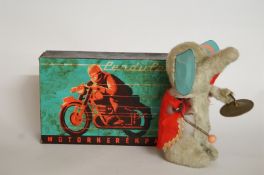 A boxed motorbike and toy elephant