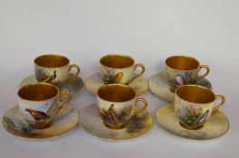 A set of six Royal Worcester coffee cups and saucers, each painted with a different wild bird to