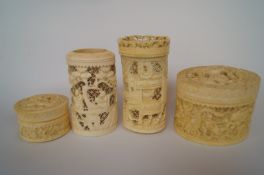 Two ivory decorative carvings and two trinket boxes.