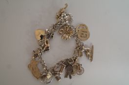Silver charm bracelet with charms, and fish pendant with chain