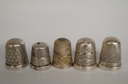 A collection of five silver thimbles, one late Victorian, one Charles Horner, and three others