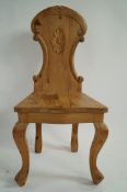 A 20th century decorative pine hall chair