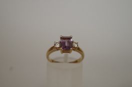 An amethyst and cubic zirconia three stone 9ct gold dress ring, finger size M