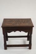 An 18th century oak table with twin drawers