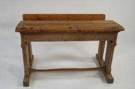 A child's school bench with pine top and a base of oak or possibly ash