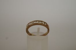 A 9ct gold cubic zirconia half hoop ring, finger size N