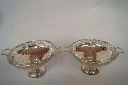 A pair of silver bon-bon dishes, Mappin and Webb Birmingham 1924, the two handled bowls on a short