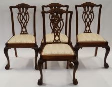 A set of four mahogany Chippendale style dining chairs, each with ball and claw feet