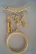An ivory bangle, with various ivory animals.