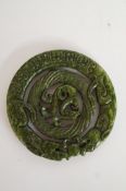 A green hardstone carved pendant
