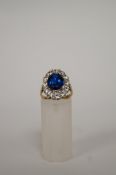 A blue and colourless synthetic stone cluster ring, finger size M 1/2