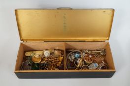 A tin of assorted costume jewellery