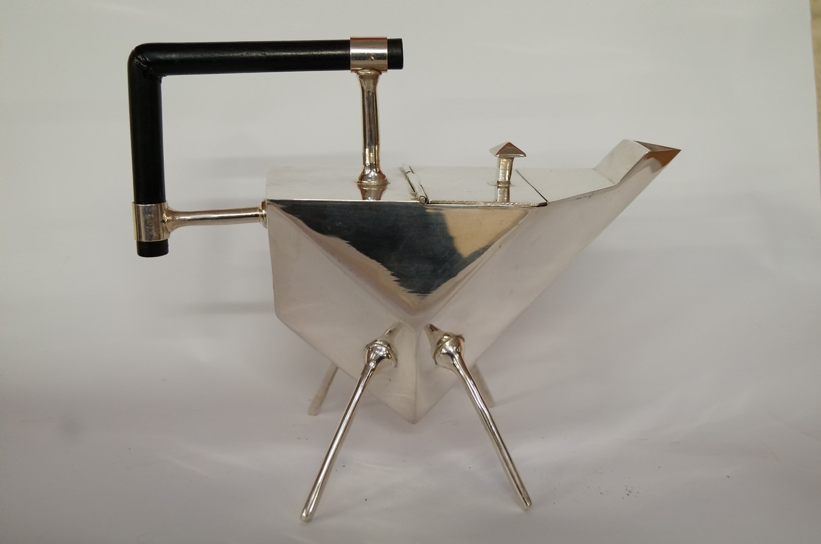 A copy of a teapot after a design by Christopher Dresser, 22.5cm long