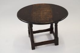 A 19th century small oak drop leaf table
