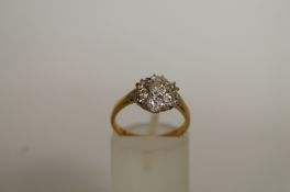 WITHDRAWN A seven stone diamond cluster ring, 18ct gold, the diamonds totalling approximately 0.