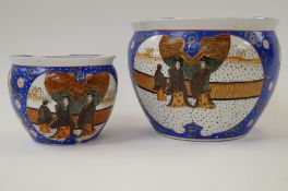 Large and small Chinese fish bowl planters decorated in blue and gold