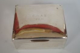 A silver cigarette box, London 1918, plain with an inscription; 10.8cm long