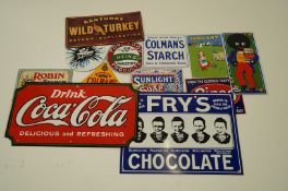 A collection of reproduction enamel advertising signs