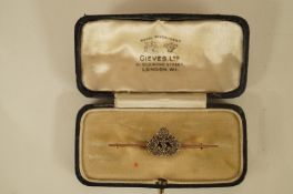 A rose diamond set Royal Navy sweet heart bar brooch, stamped '18ct' and 'Plat' , 5cm long, 3.7