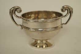 A silver mustard pot with liner, Birmingham 1924, of plain oval outline with a domed hinged cover,