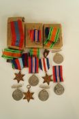 A collection of various WWII medals, all unnamed