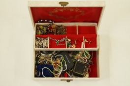 A quantity of assorted costume jewellery housed in a jewellery case