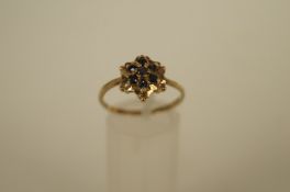 A seven stone sapphire cluster ring, 9ct gold ring, with four single cut diamond points, finger size