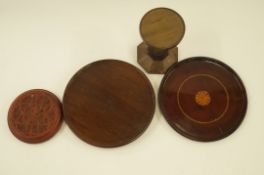 A wig stand, two mahogany plates and one other item