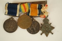 Three WWI medals, along with a service medal from the H.M.S. excellent all awarded to 230230 J.