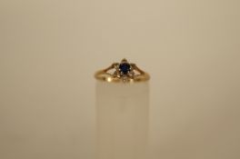 A seven stone synthetic cluster 9ct gold ring, finger size M 1/2, 1.1g gross